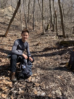 Alex smiles while hiking the Rachel Carson Trail