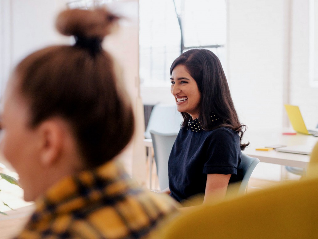 Smiling women in a meeting.