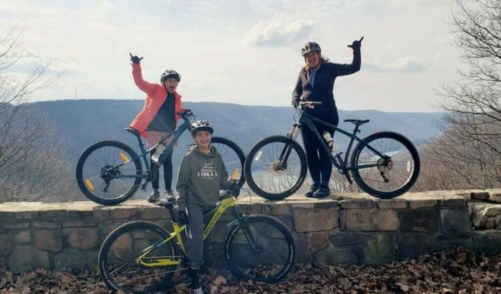 Family posing with bikes.
