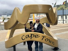 Man and woman posing with Cape Town sign.