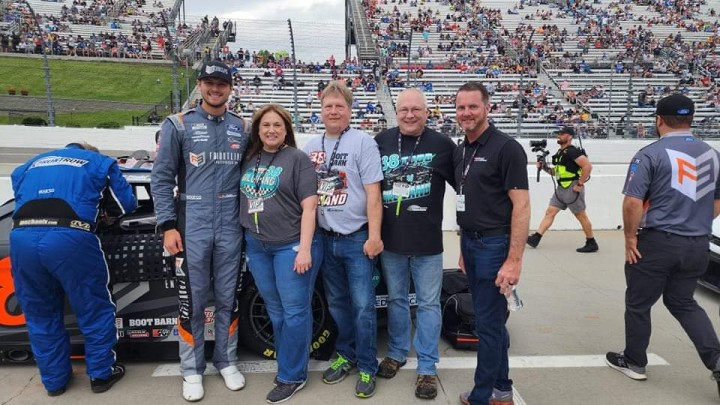 Woman with group of people at Nascar race