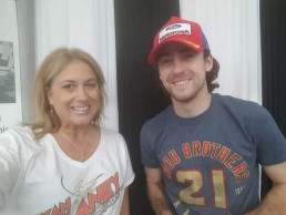 Woman posing with Ryan Blaney, NASCAR driver.
